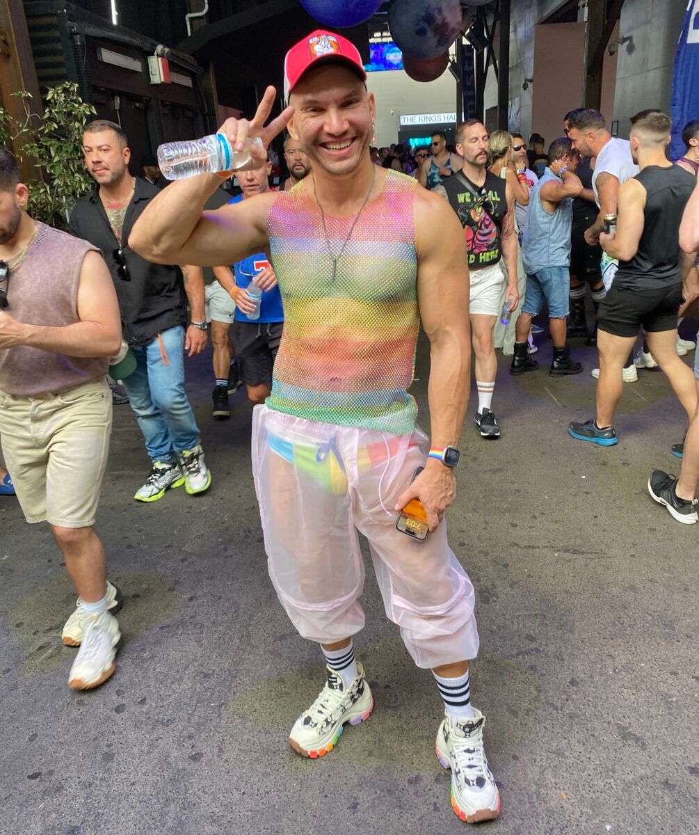 A MUSCLE BOY IN A RAINBOW TANK TOP