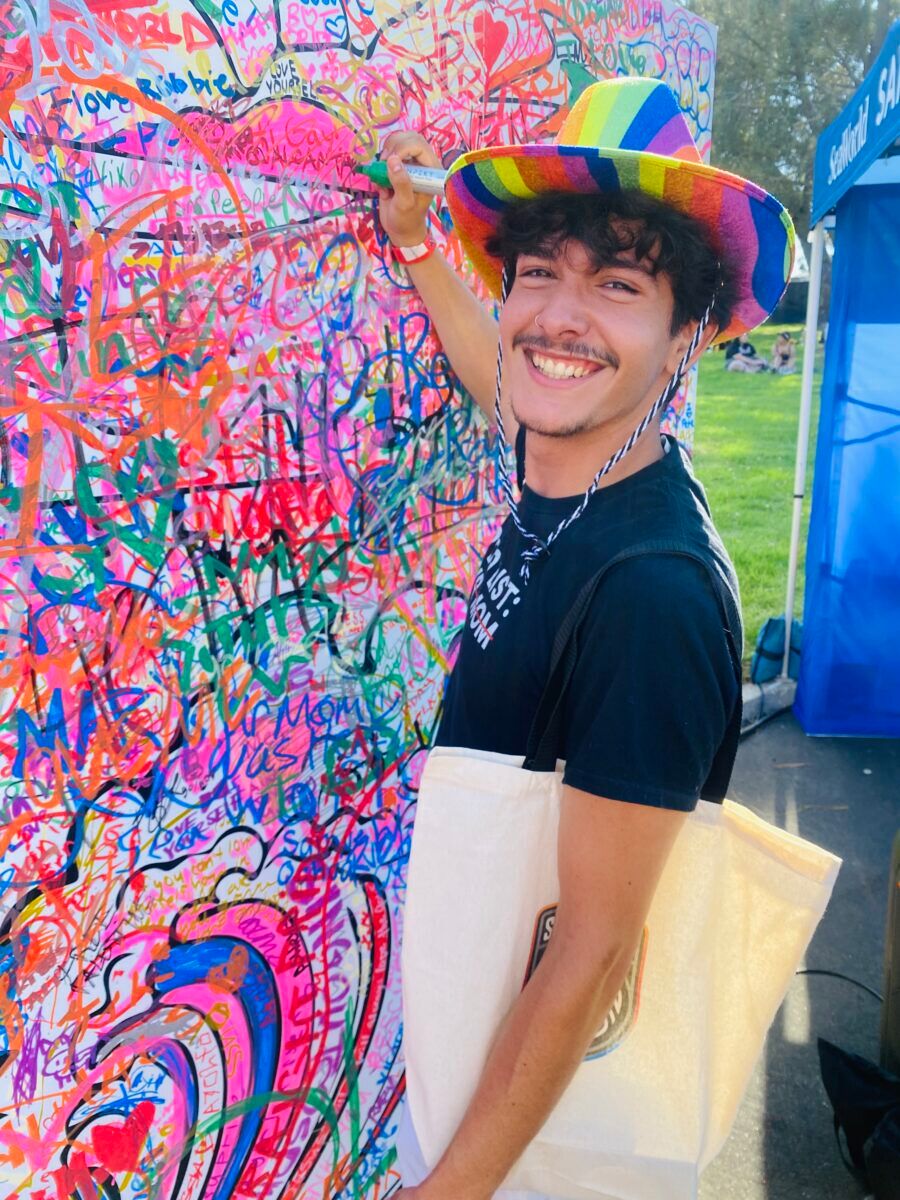Local twink signing the Sea World mural.