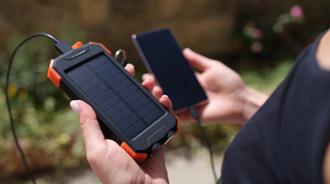 Man holding power bank and cell phone