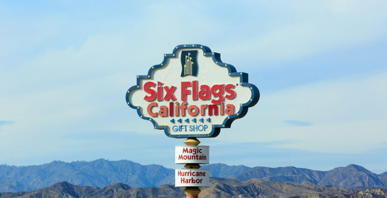 Six Flags California sign with the mountains in the background.