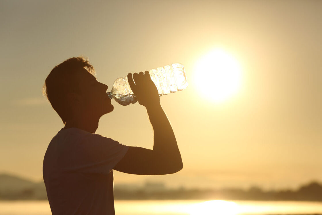Man drinking water on beach