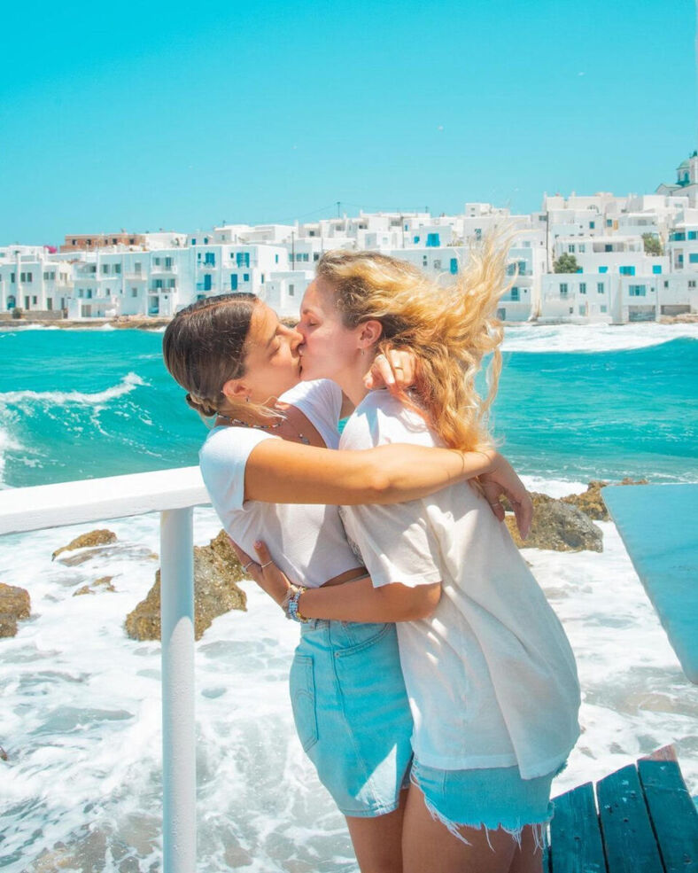 Gabi and Shanna on a boat with turquoise water behind them