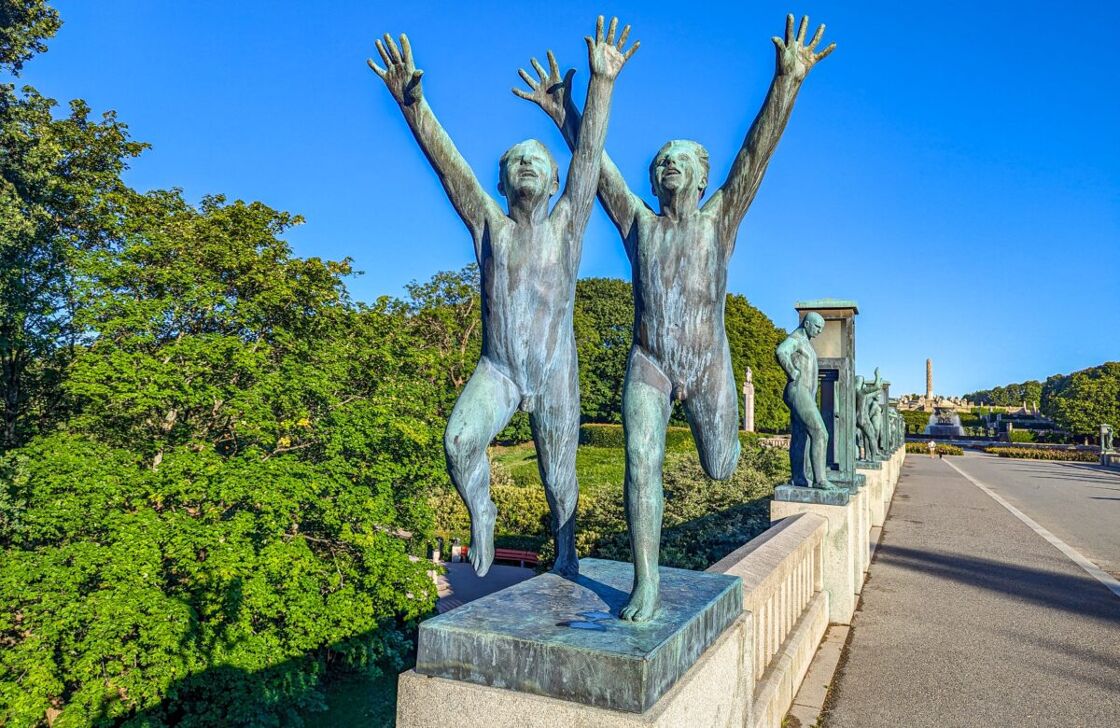 Bronze sculplture located on the bridge of two boys running, their hands in the air. A statue at Vigeland Sculpture Park