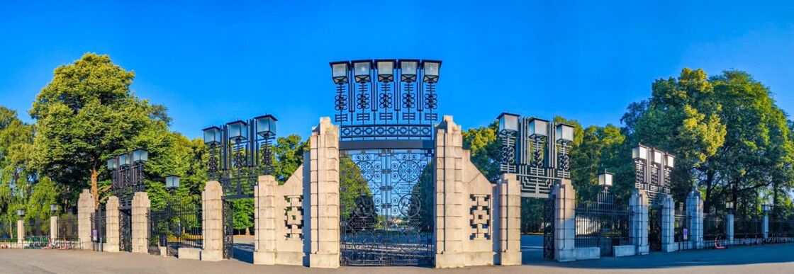 Wide shot of the main gate which is made of stone and wrought iron with art deco and art nouveau touches The entrance to Vigeland Sculpture Park