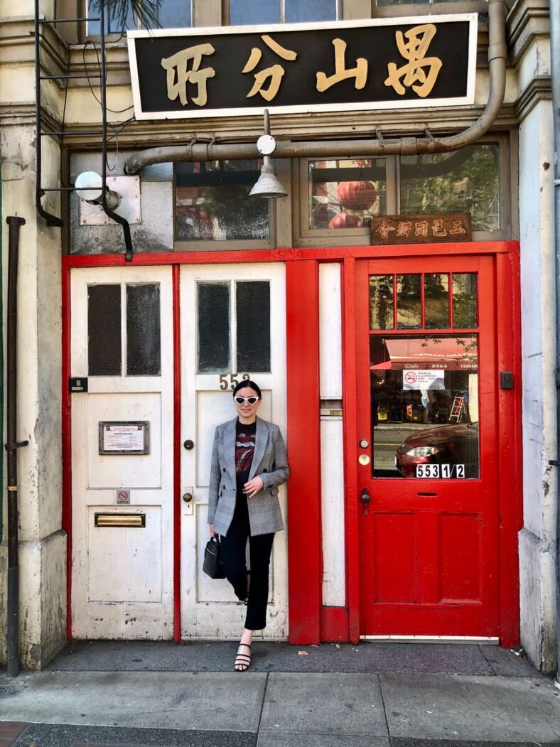 The author stands before the entry to a shop in Victoria's Chinatown