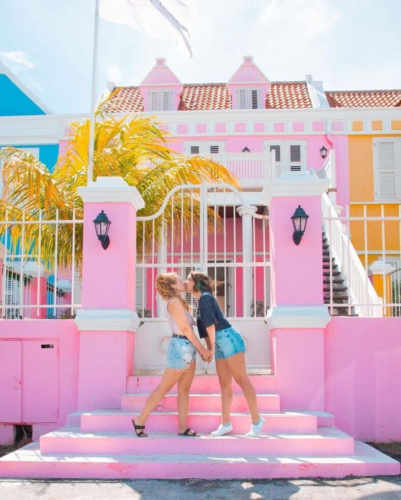 Gabi and Shanna in front of a pink building