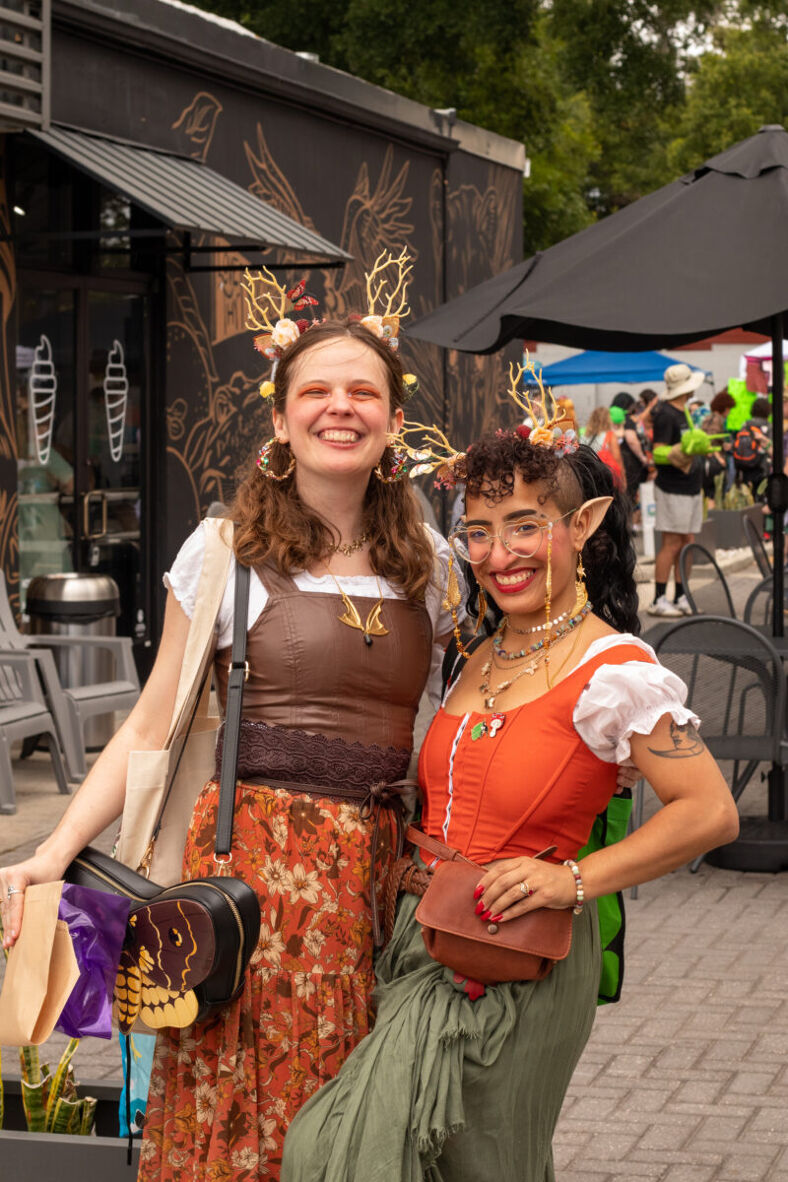 Two forest sprites smile at the camera showing off their adorable bags, pointy ears and faerie accessories. 
Photographer: Jordan Macaulay