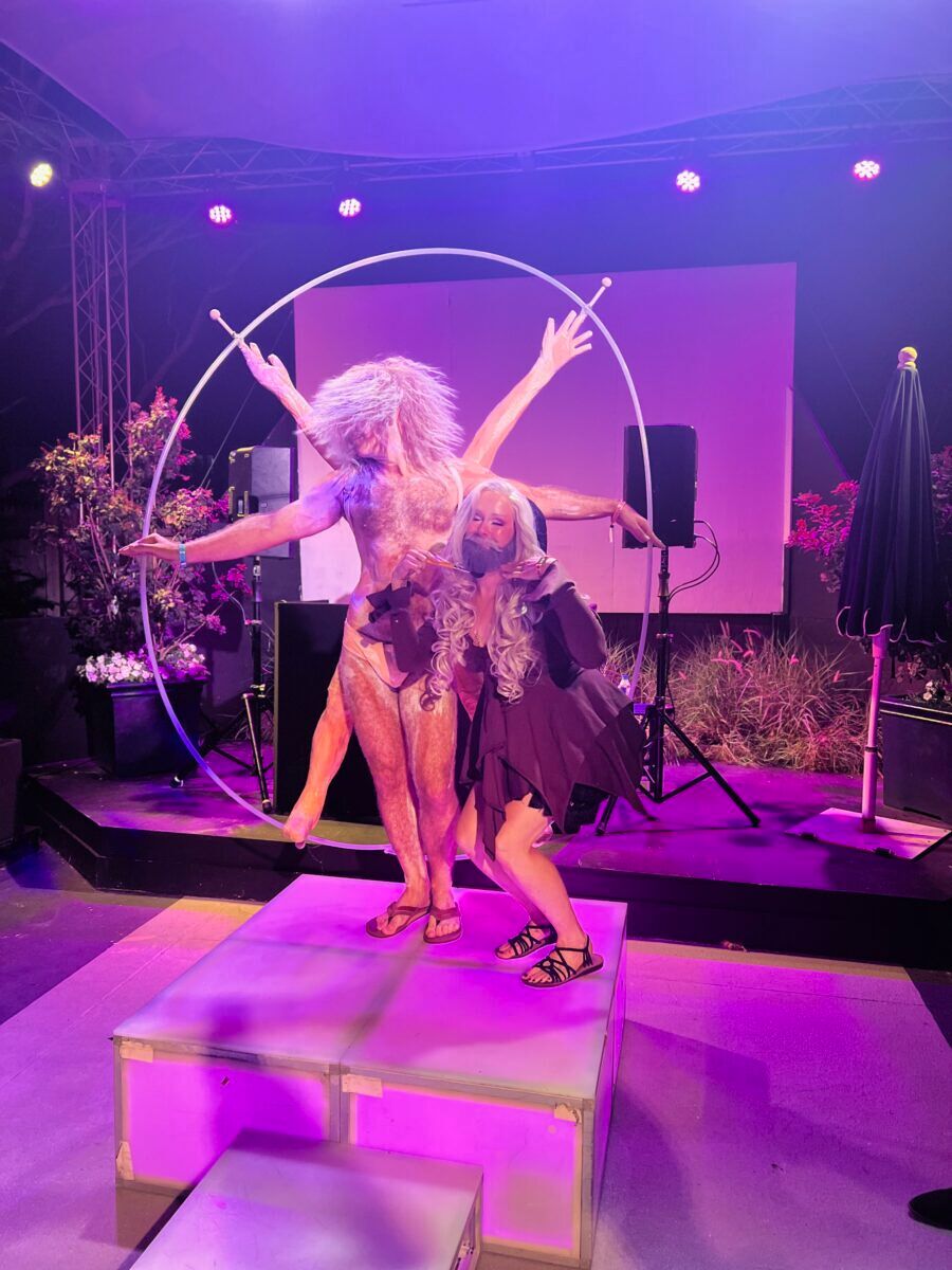 A stage with a performance of Da Vinci's Vitruvian Man as the forefront 