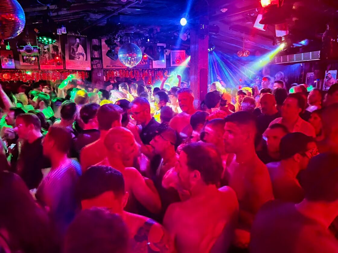 A packed dance floor full of handsome men