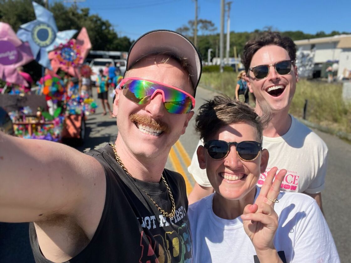 Three happy people smile for a selfie