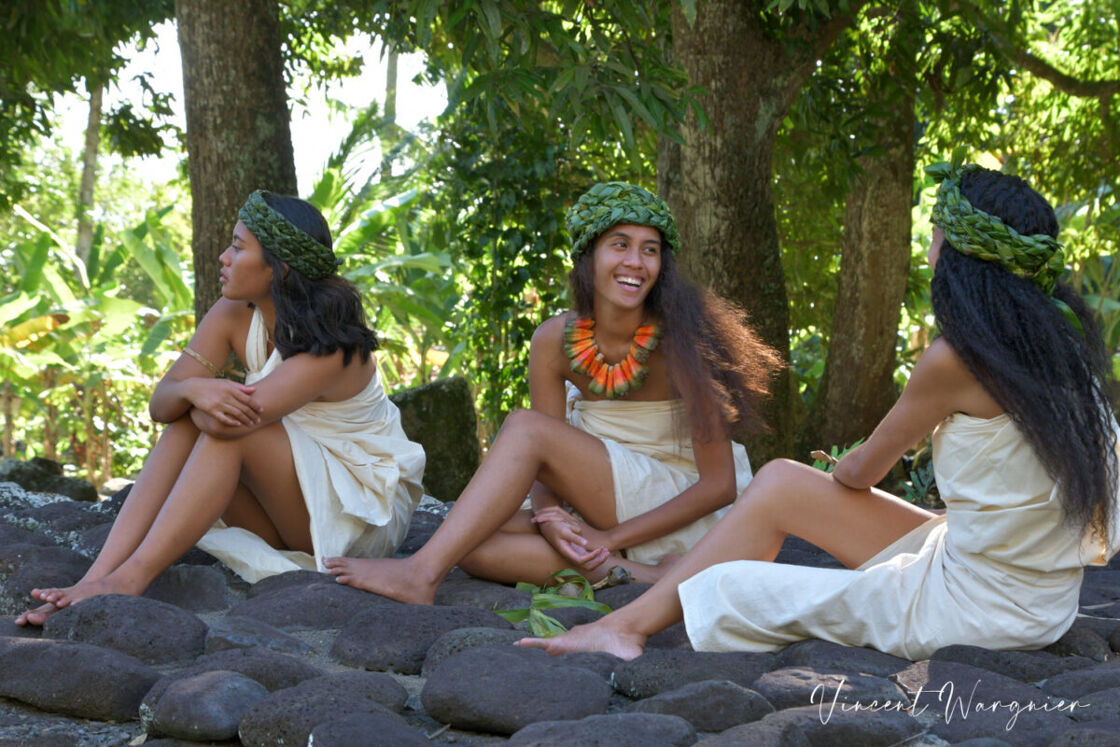 Three women wear traditional pareos in French Polynesia.