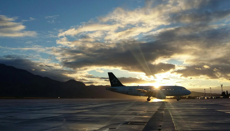 Plane on the tarmac in front of a beautiful sunset