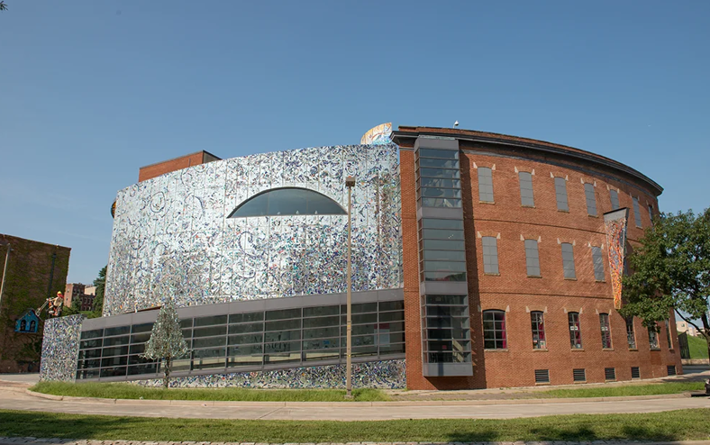 The exterior of AVAM. A shining mosaic wall paired with a classic brick exterior. 