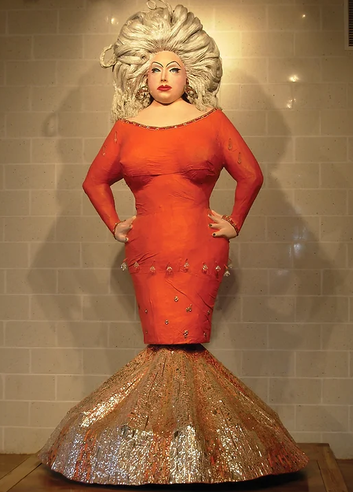 A 10ft tall Paper Mache statue of famous drag queen Divine wearing a red bedazzled mermaid cut dress. 