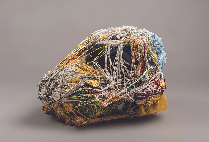 A mess of differently textured yarn and foam wrapped together.