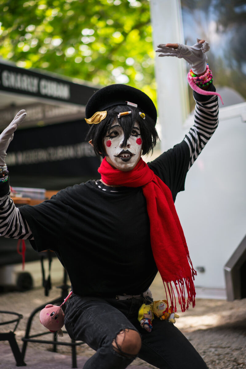 A drag performer in black and white clown make-up strikes a graceful pose.
Photographer: Tyler Karon
Special effects: Emmett Wagner