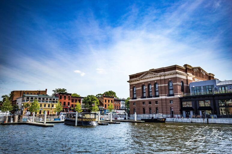 A beautiful photo of Fell's Point with a bright blue sky behind it. 