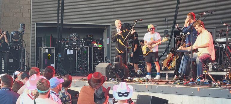 John Waters on stage with performers 