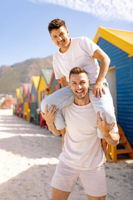 Gay travel content creators Matthew Schueller (top) and Michael Lindsay at Muizenberg Beach, Cape Town, South Africa.