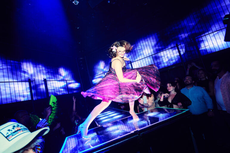 A woman in a pink dress performs at DISCOSHOW