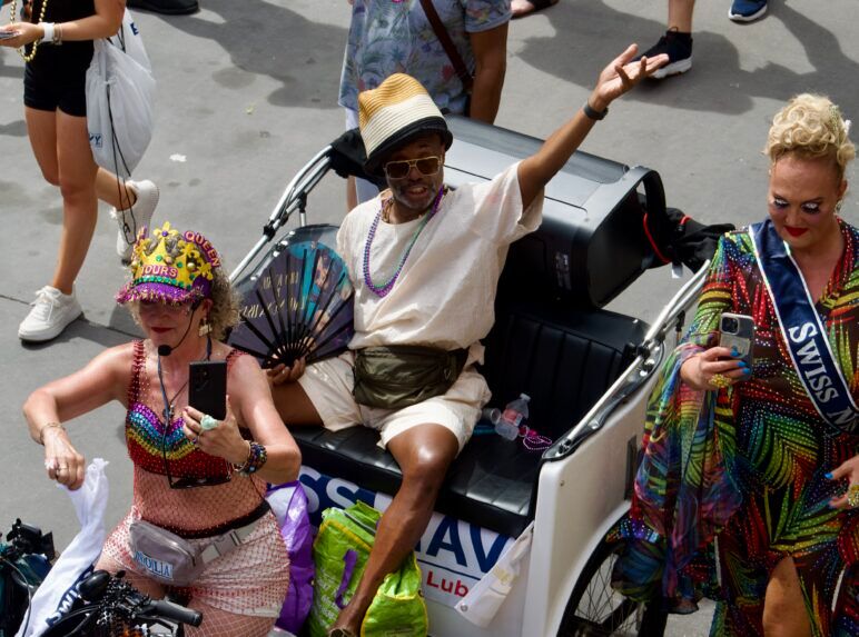 A parade participant waves to the crowd