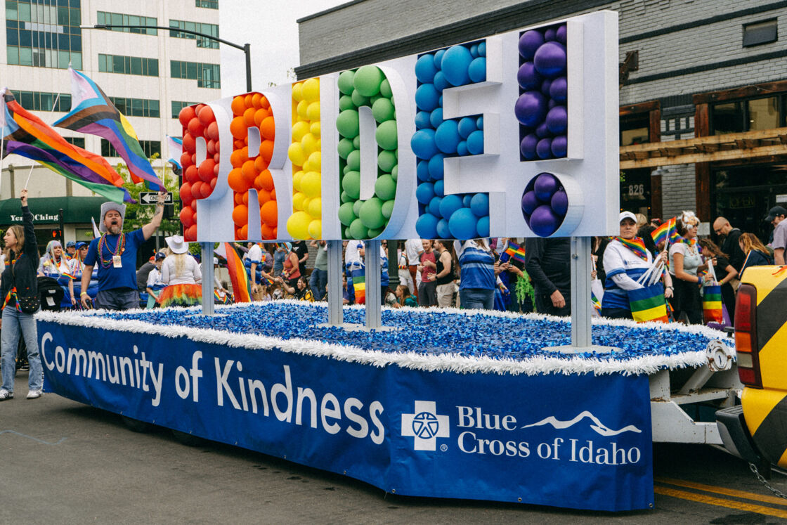 The Blue Cross float in Boise Pride parade has the word PRIDE! spelled out in rainbow colored balloons