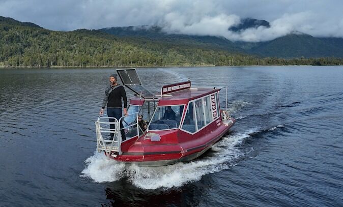 Ernest White II stand on a boat