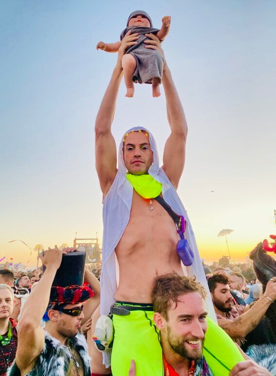 Dusty evoking Lion King vibes with his baby doll "Dustica" at Mayan Warrior.