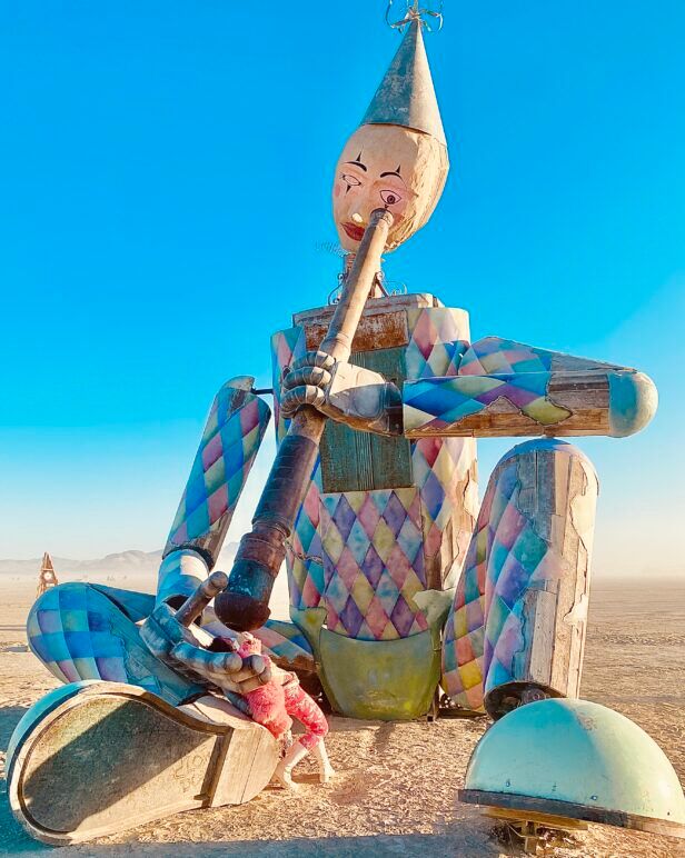 Koko Bot, a metallic colossus reminiscent of Max Fleischer's cartoon clown blurs the line between art and audience. Burners are encouraged to recline in his hand and glance into its telescope, revealing a cosmic kaleidoscope inside.