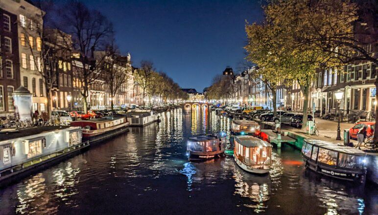 A canal in Amsterdam at night.