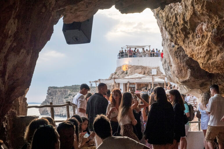 The cliffside cave at Cova d’en Xoroi offers the perfect spot to watch the sunset.