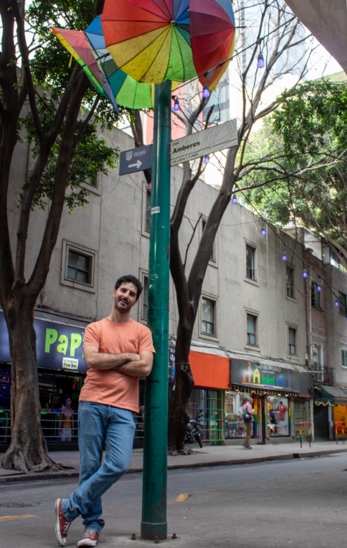 Chapu Garza leans against a streetsign in Zona Rosa