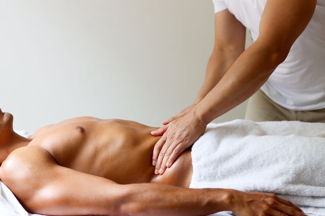 man receiving a massage from a male therapist