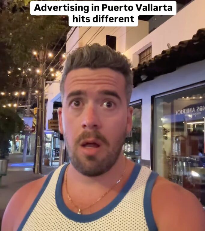David Jon Acosta stands outside a gay bar with a shocked look on his face.