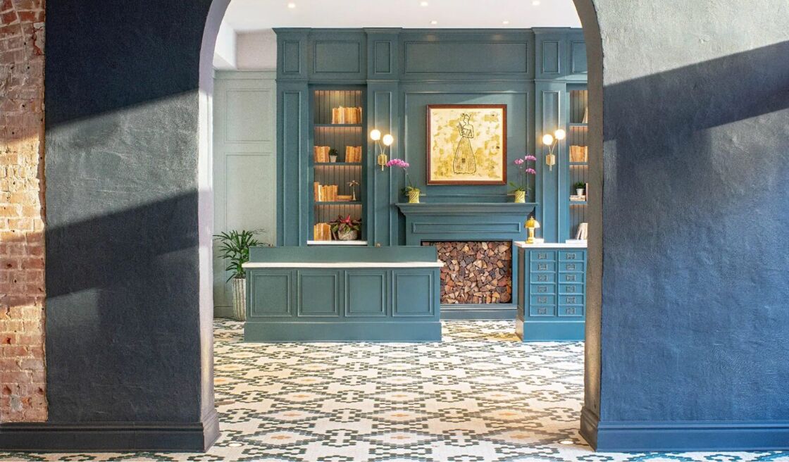 A hotel lobby with blue furniture and walls