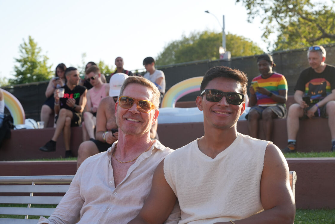 Two men sitting at Weho Pride