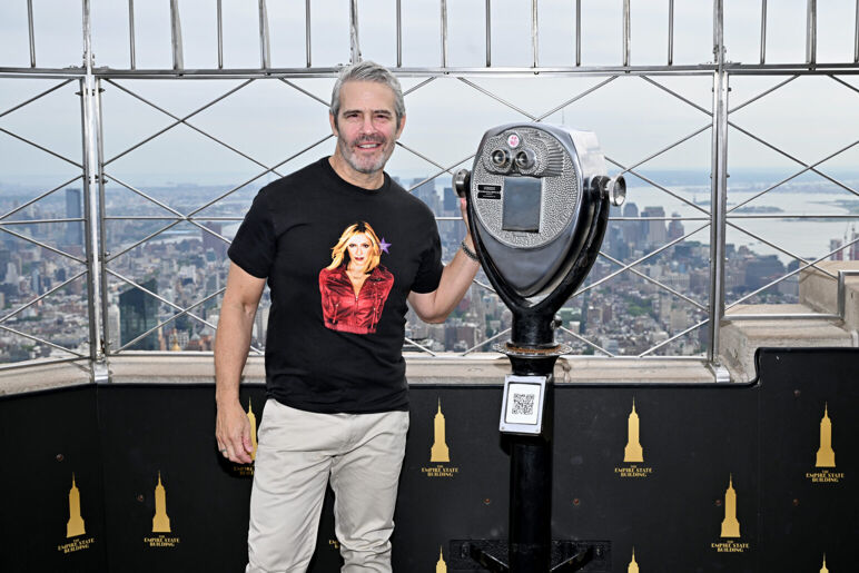 Andy Cohen poses with binoculars on the deck of the Empire State Building.