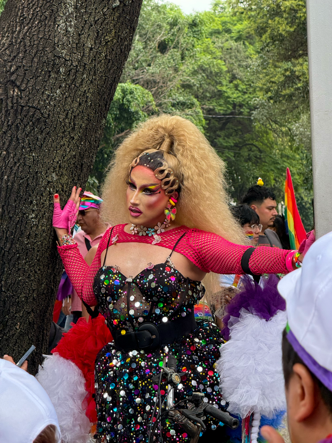A drag queen poses up against a tree at Mexico City Pride.