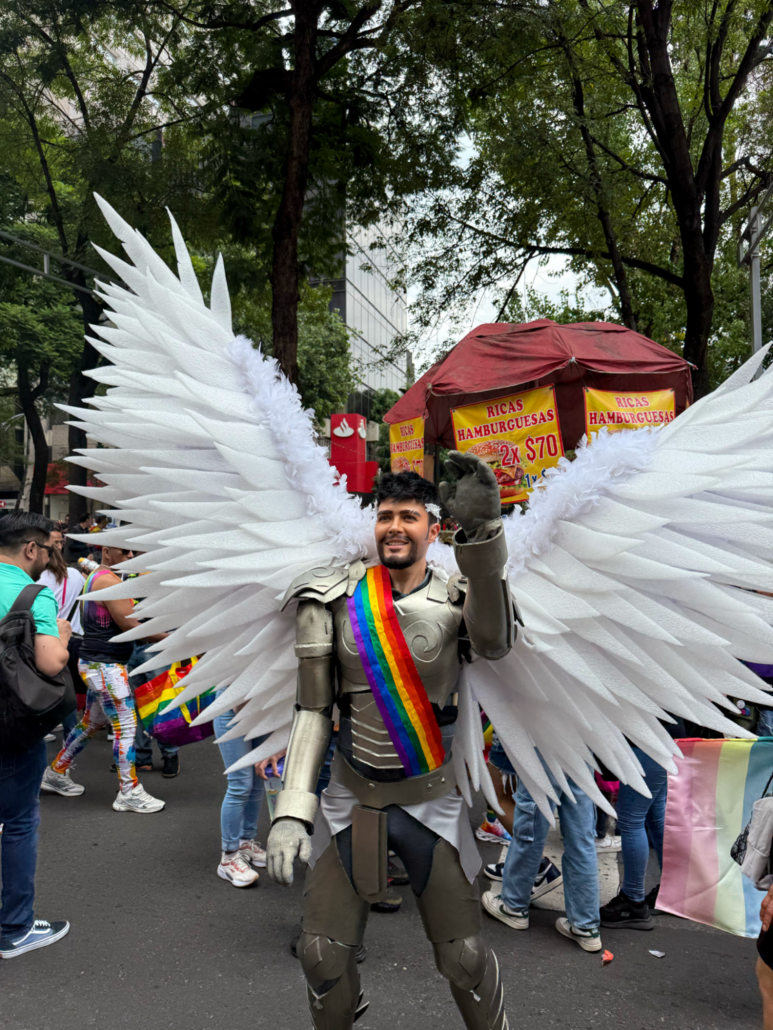 A man dressed as a knight with angel wings waves at Mexico City Pride.