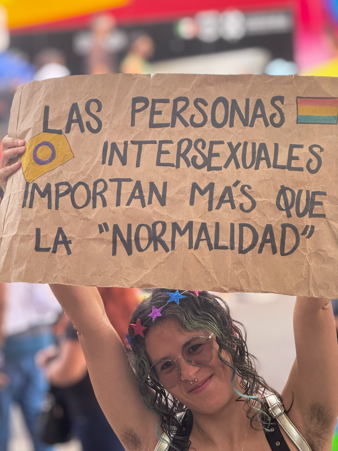A Mexico City Pride attendee holds up a sign reading