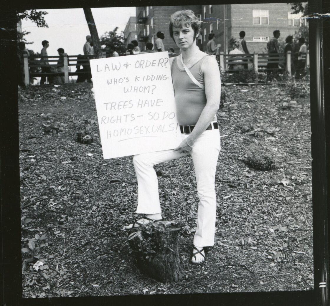 A gay man holds a protest sign in Forest Hills, Queens.