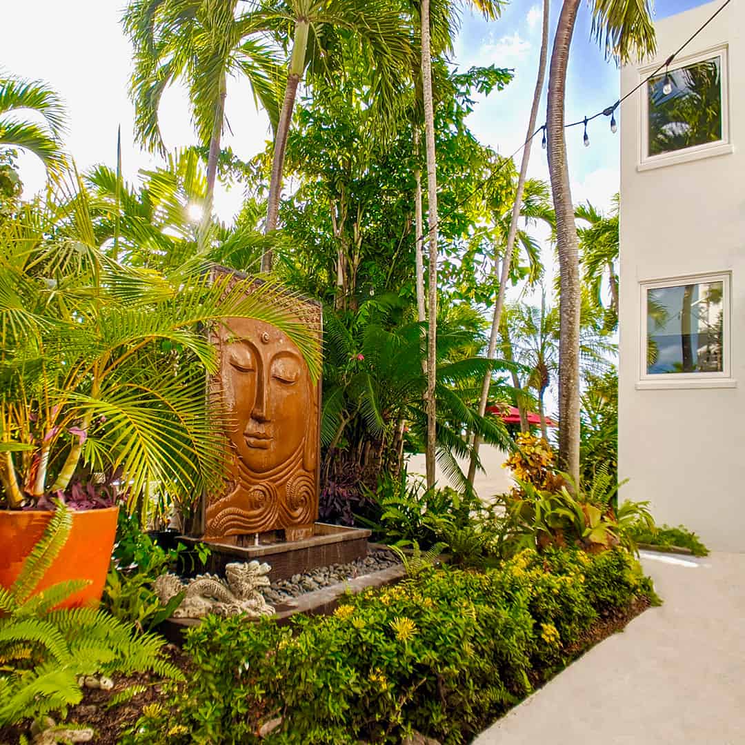Lush greenery and decoration outdoor near the pool at St. Croix's Sand Castle on the Beach hotel.