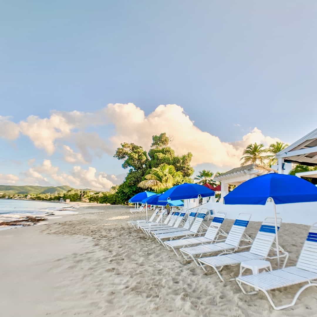 Beach chairs arranged on the sand in front of St. Croix's Sand Castle on the Beach hotel.