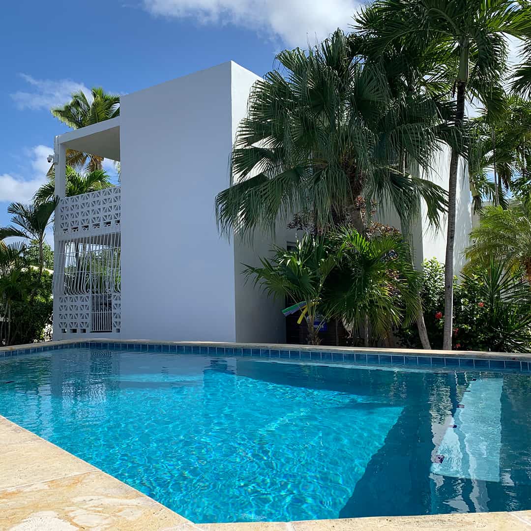 A freshwater pool pictured near palm trees at St. Croix's Sand Castle on the Beach hotel.