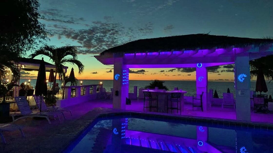 The pool in front of the beach, lit up at night, at St. Croix's Sand Castle on the Beach hotel.