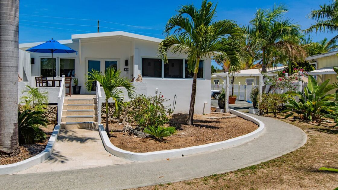 The Dolphin Villa pictured from outside amongst palm trees at St. Croix's Sand Castle on the Beach.