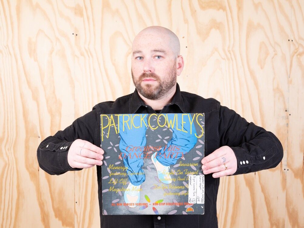 Ben Schonberger holds up a Patrick Cowley record
