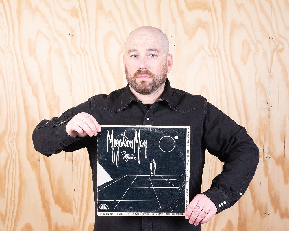 Ben Schonberger holds up a Patrick Cowley record