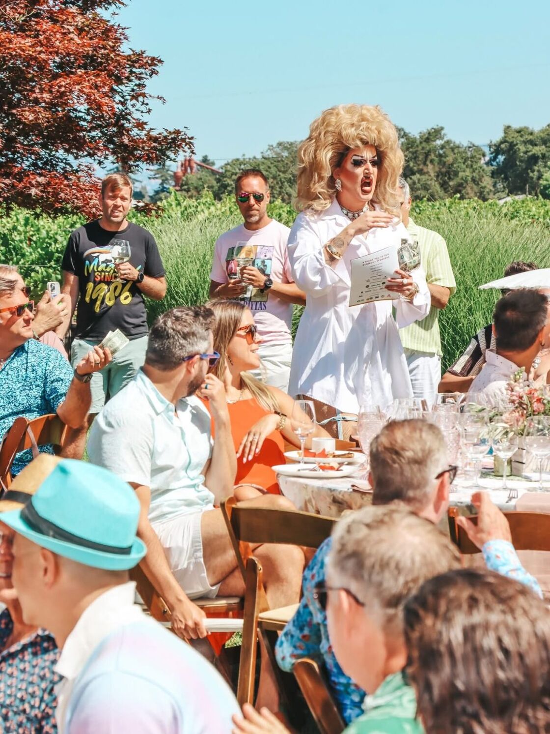 A drag queen performs for guests at an outdoor drag brunch at Gay Wine Weekend.