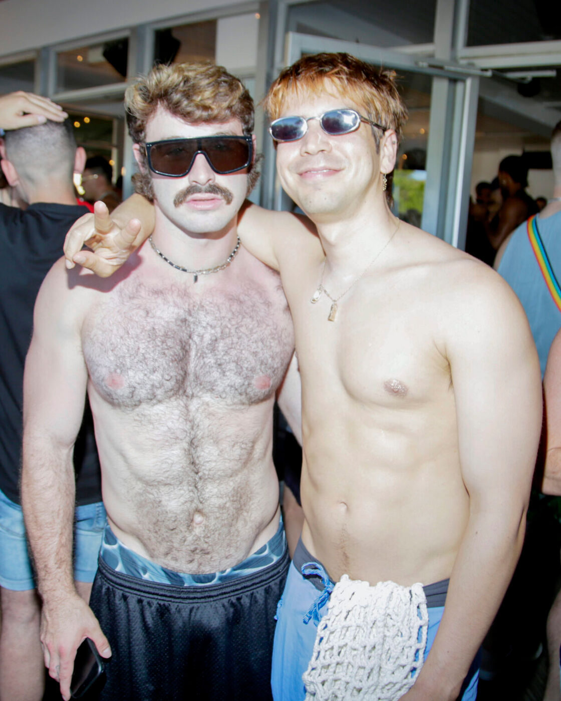 Gallipony and Julio Torres pose shirtless outdoors at a Fire Island Pines party. 